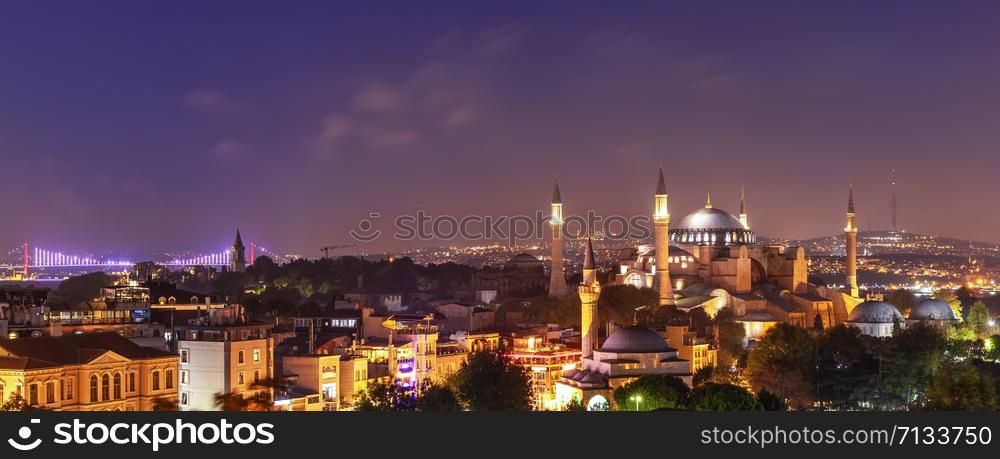 Hagia Sophia and the Bosphorus Bridge, evening panorama of Istanbul.