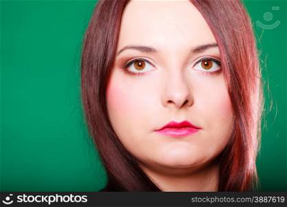 Hair care, hairdresser and hair stylist. Young red haired woman with classical coiffure on green background. Studio shot.