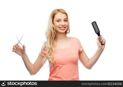 hair care, hairstyle, hairdressing and beauty people concept - young woman or teenage girl with scissors and hairbrush