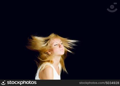 Hair care. Young attractive blond woman shaking with head