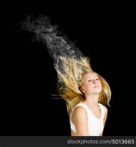 Hair care. Young attractive blond woman with hair in smoke