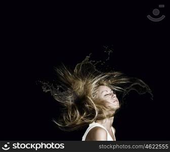 Hair care. Young attractive blond woman with hair in splashes