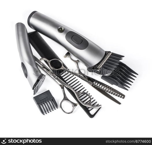 hair clipper, comb and scissors on white background