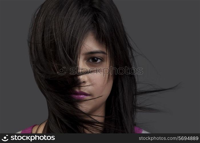 Hair covering half of a woman&rsquo;s face