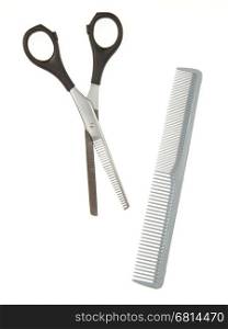 Hair cutting shears and comb isolated on white