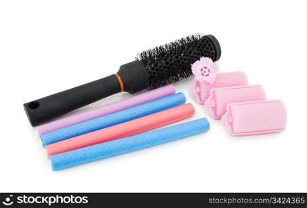 Hair dressing tools - hair brush and foam curlers with pink flower. Isolated over white background.