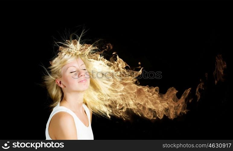 Hair in fire. Young attractive blond girl with hair burning with fire