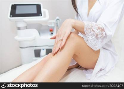 Hair removal, cosmetic body care concepts - epilation, depilation, shugaring. Beautiful soft skin, woman&rsquo;s legs with perfect skin, woman&rsquo;s hand touches her perfectly smooth leg. Hair removal, cosmetic body care concepts - epilation, depilation, shugaring. Beautiful soft skin, woman&rsquo;s legs with perfect skin, woman&rsquo;s hand touches her perfectly smooth leg.