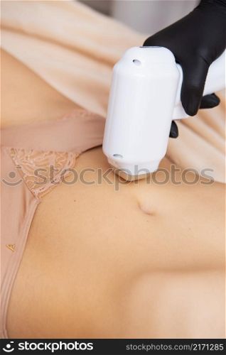 Hair removal on the abdomen, legs and all parts of the body, a girl in beige underwear concept of laser hair removal. Hair removal on the abdomen, legs and all parts of the body, a girl in beige underwear concept of laser hair removal.