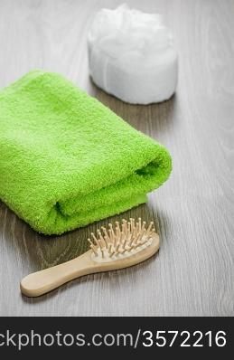 hairbrush and bath sponge with towel