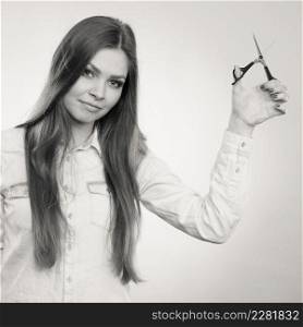 Haircare concept. Cutting and trimming. Young prefessional female barber hairstylist with scissors. Portrait of long haired girl prepared to styling hair.. Young professional hairdresser with scissors.