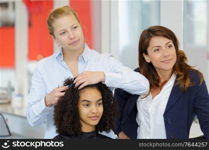 hairdresser doing hairdo on curly hair