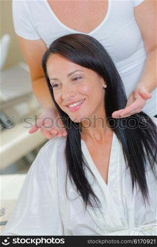 Hairdresser giving client advice
