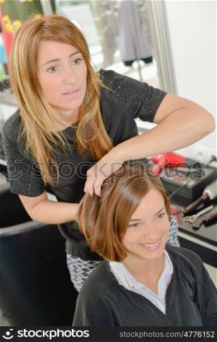 hairdresser holding customer's hair into style