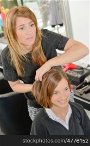hairdresser holding customer's hair into style