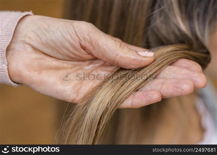 hairdresser holding tuft hair