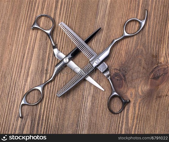 hairdresser scissors on wooden background