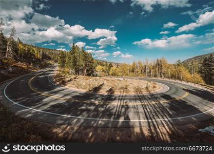 Hairpin turn at autumn in Colorado, USA. . Highway with hairpin turn (switchback) at autumn sunny day in Rocky Mountain National Park. Colorado, USA.