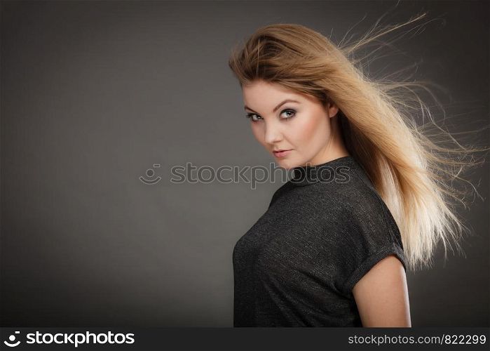 Hairstyle and haircare concept. Portrait of blonde charming attractive young lady with open waving hair. Woman with healthy and beauty hairdo coiffure.. Gorgeous blonde woman with open waving hair.
