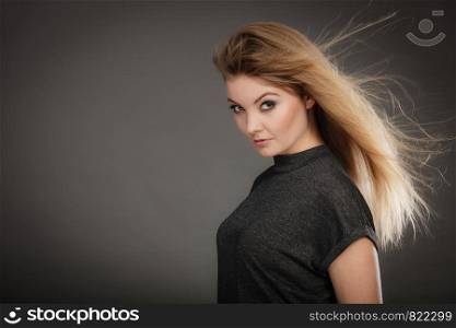 Hairstyle and haircare concept. Portrait of blonde charming attractive young lady with open waving hair. Woman with healthy and beauty hairdo coiffure.. Gorgeous blonde woman with open waving hair.