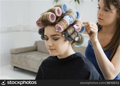 Hairstylist Rolling Hair of Model