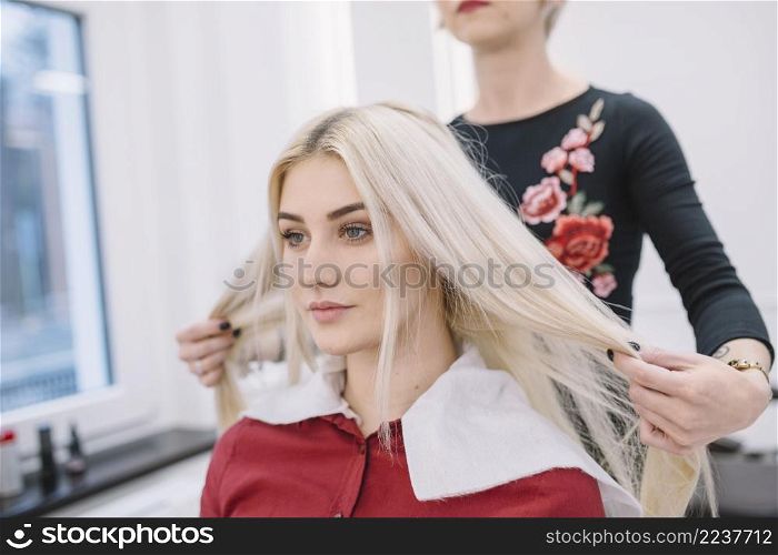 hairstylist working with blonde salon