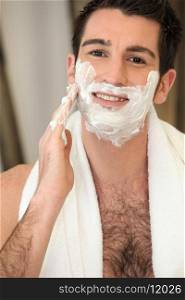 hairy man shaving his face