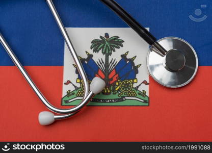 Haiti flag and stethoscope. The concept of medicine. Stethoscope on the flag as a background.. Haiti flag and stethoscope. The concept of medicine.