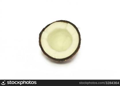 half a coconut lying on a white background