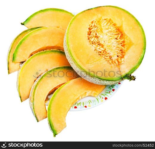 half and slices of ripe sicilian muskmelon (cantaloupe melon) on plate isolated on white background