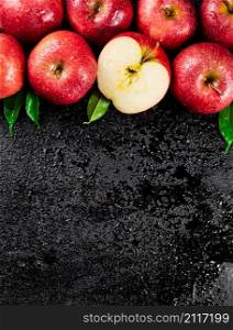 Half and whole fresh apples. On a black background. High quality photo. Half and whole fresh apples.