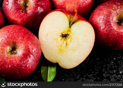 Half and whole fresh apples. On a black background. High quality photo. Half and whole fresh apples.