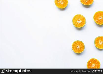 Half-cut oranges on white background. Copy space