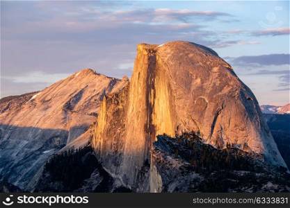 Half Dome rock formation close-up in Yosemite National Park summer sunset view from Glacier Point. California, USA.