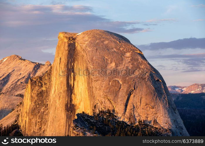 Half Dome rock formation close-up in Yosemite National Park summer sunset view from Glacier Point. California, USA.