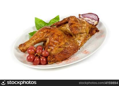 Half grilled chicken closeup with grape and greens on a white