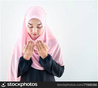 Half length front view of asian young beautiful muslim woman prayer dress hijab pray meditation in mosque for eid mubarak life and soul fasting of international islamic ramadan Namaz.