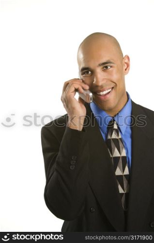 Half length portrait of African American man in suit talking on cellphone.