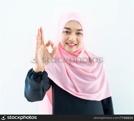 Half length portrait of asian beautiful Muslim young woman wearing business attire and hijab with mixed poses and gestures isolated on grey background. Suitable for technology, business finance theme.