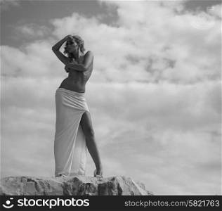 Half-naked lady looking at the rocks