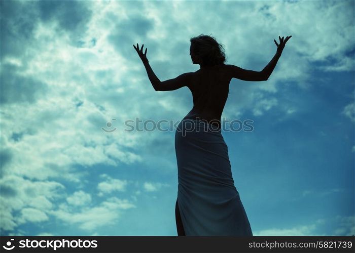 Half-naked lady posing over the blue sky