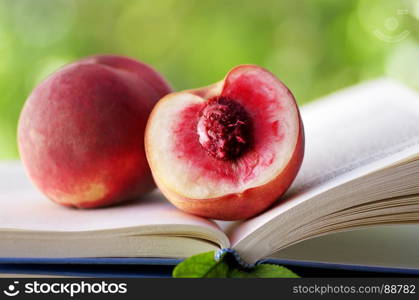 half of peach in open book, green background