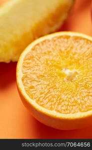 Half of tasty and healthy tropical fruit orange on yellow background. Natural diet, refreshing. Closeup background.. Juicy and ripe sweet vegetarian slice orange on yellow background, close up