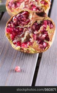 Half pomegranate over a table, vertical image