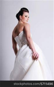 half-turned of bride dressed in white wedding dress