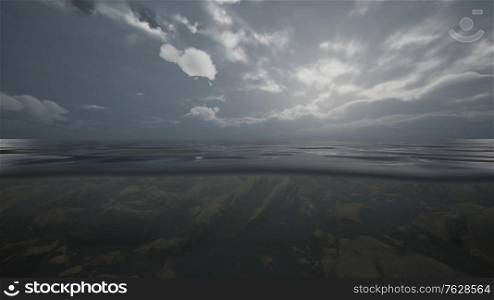 Half Water Ocean shoot under water line. Dark sunset sky with Grey Clouds over water surface. Half Water Ocean shoot under water line