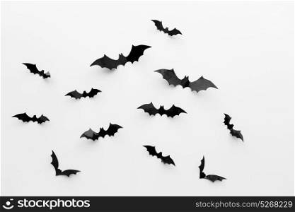 halloween and decoration concept - black paper bats flying over white background. black paper bats over white background
