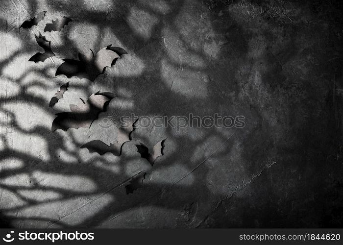 halloween and decoration concept - black paper bats, moonlight and scary trees shadows background. halloween and decoration concept - black paper bats and scary trees shadows background