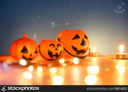 Halloween background candlelight orange and blue decorated holidays festive concept / funny faces jack o lantern pumpkin halloween decorations for party accessories object with candle light bokeh