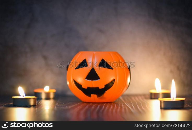 Halloween background candlelight orange decorated holidays festive concept / funny faces jack o lantern pumpkin halloween decorations for party accessories object with candle light on wood